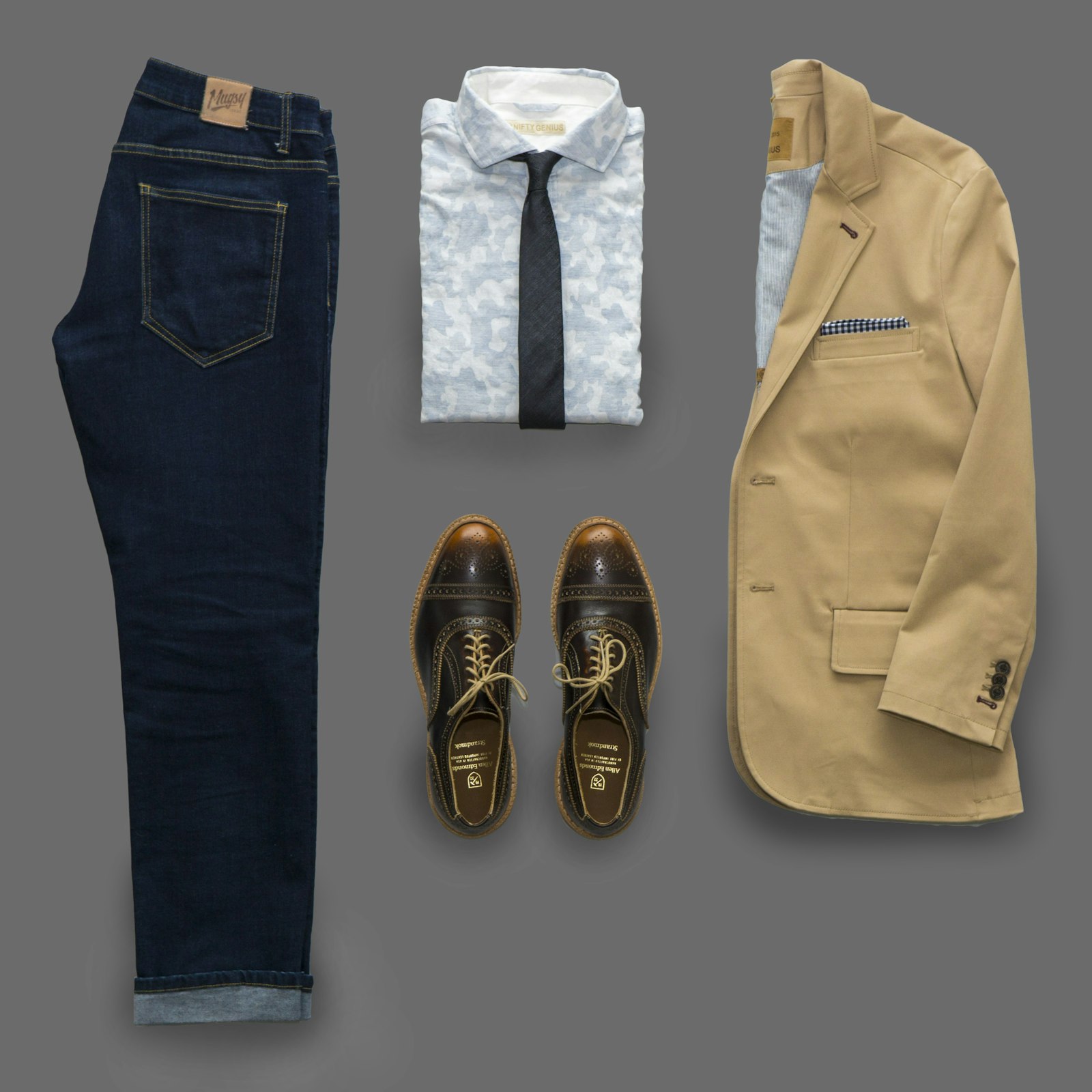 Weekend clothes laid out: denim, field coat, and leather shoes